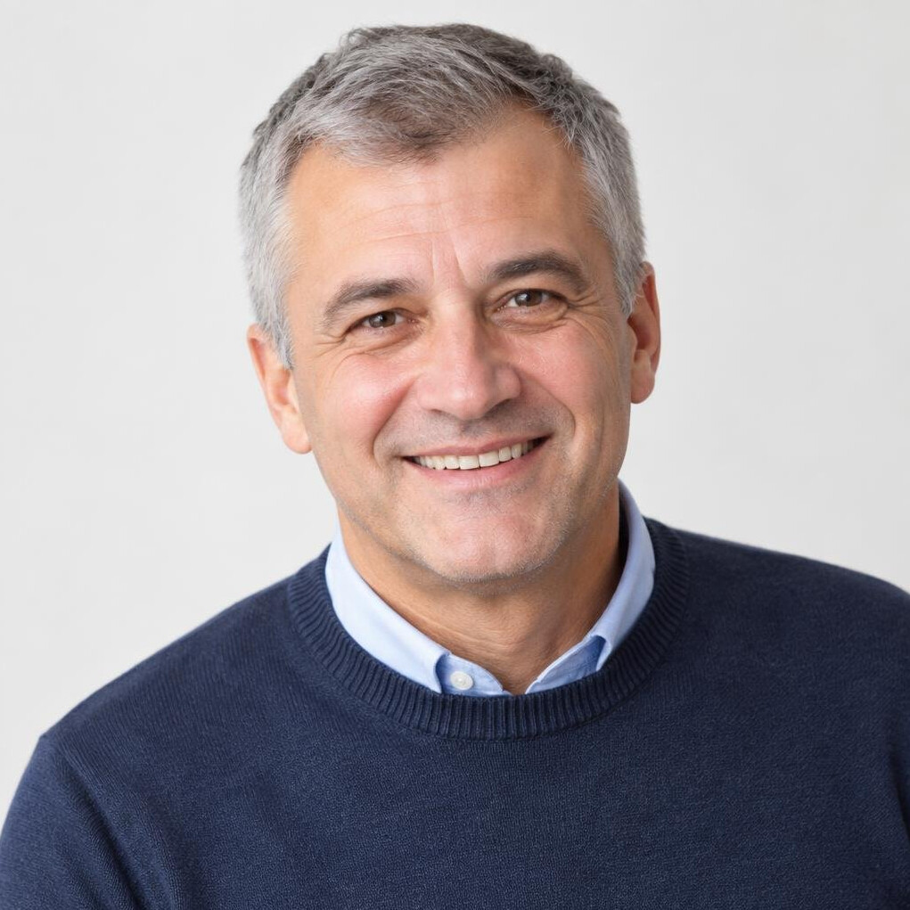 Studio portrait of a middle aged Croatian man mentor smiling warmly